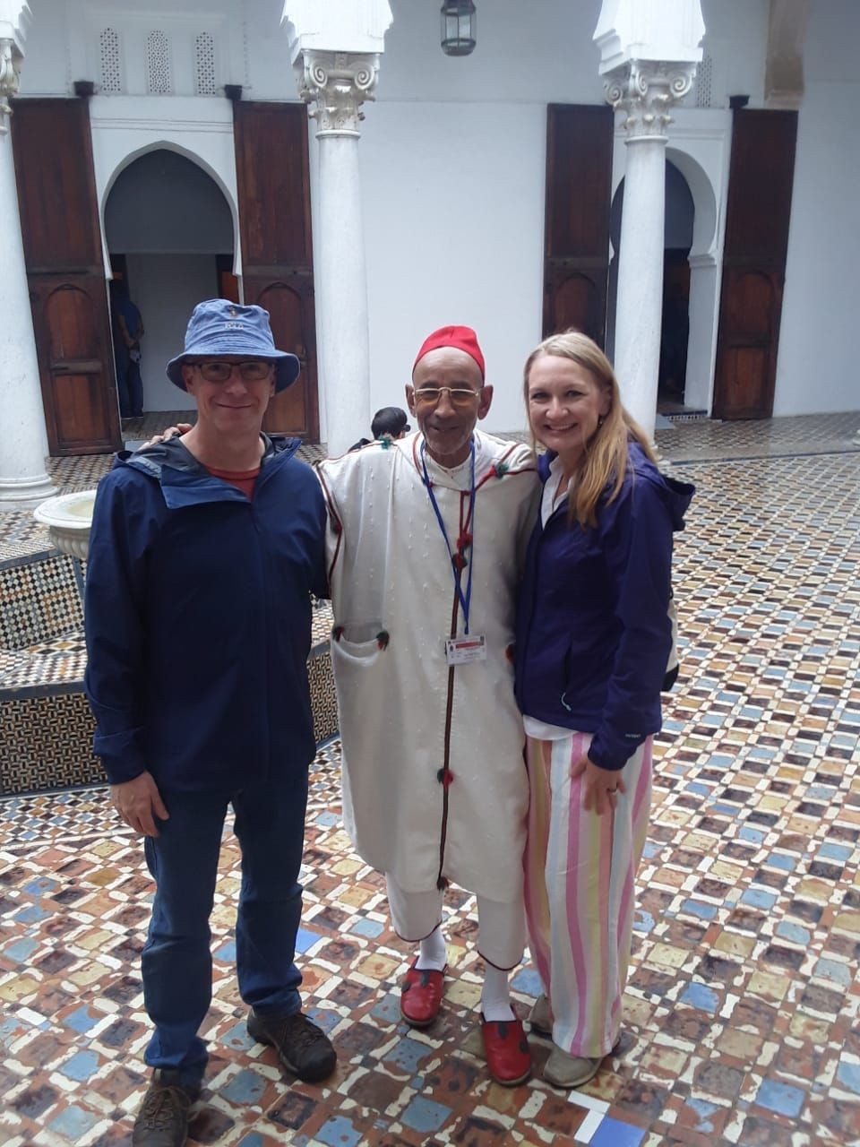 A vibrant scene showcasing the cultural heritage of Tangier-Assilah, highlighting traditional practices and interactions between locals and visitors, symbolizing the preservation of Moroccan traditions.